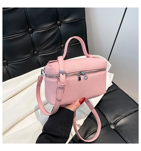 Detailed view of pink pebble leather vanity case with silver zippers and handle