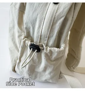 Detail of drawstring side pocket on beige nylon backpack with adjustable toggle