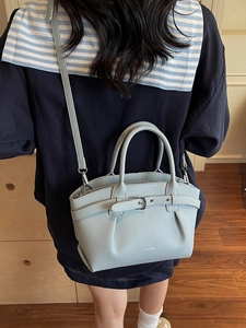 Elegant light blue lychee pattern handbag with silver buckle and adjustable shoulder strap