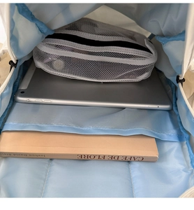 Internal view of drawstring backpack showing large capacity and mesh zipper pocket