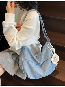 Light blue denim crescent bag with large capacity and capybara tag for daily commute