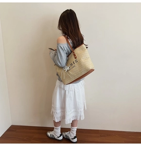 Detail of rainbow straw tote bag with leather strap and PARIS MILANO print