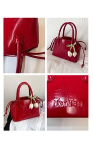 Detail shots of red patent leather bucket bag with TonTon logo and tulip charm accessory