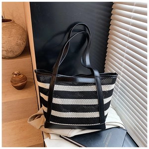 Detailed macro view of black and white striped woven mesh material on large tote bag