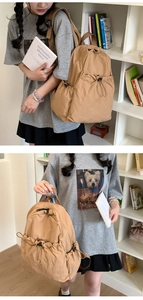 Detail of khaki drawstring backpack featuring pleated texture and side bottle pockets