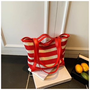 Detail of red and white striped mesh tote bag with reinforced faux leather handles