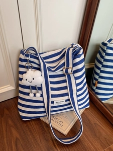 Blue and white striped canvas tote bag with a cloud pendant and adjustable strap
