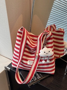 Red and white striped canvas tote bag with a plush cloud charm for women in soft light