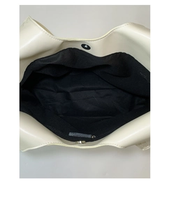 Top view of cream white tote bag interior with magnetic closure and black fabric lining