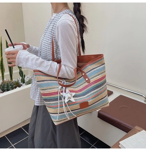 Close-up of bohemian rainbow woven tote bag featuring striped textures and star charm