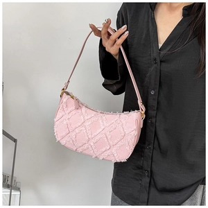 Pink quilted tweed hobo bag with fringe details shown on shoulder for sizing