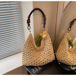 Detailed close-up of woven beige tote bag with retro dark brown wooden bead handles