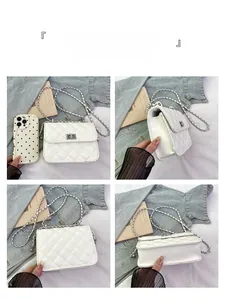 Detailed views of white quilted crossbody bag with silver rotating lock and chain strap