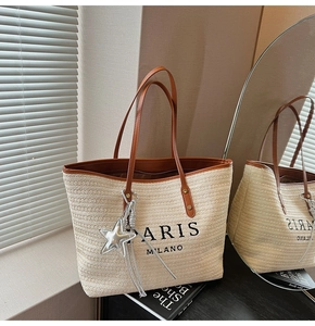 Detailed close-up of rainbow straw tote bag with Paris lettering and silver star charm