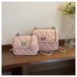 Detail of pink quilted crossbody bags with silver twist locks in two different sizes