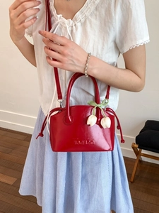 Red patent leather bucket bag with Ton Ton embossing and white tulip flower charms