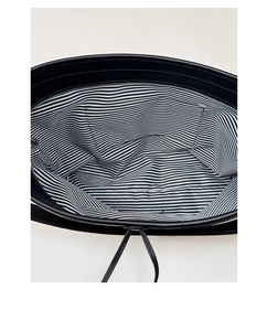 Detail view of striped lining and inner pocket of this black striped beach tote bag