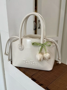 Creamy white PU leather bucket handbag with TonTon logo and floral ribbon charm