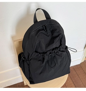 Close-up of black nylon drawstring backpack with durable zipper and wide handle