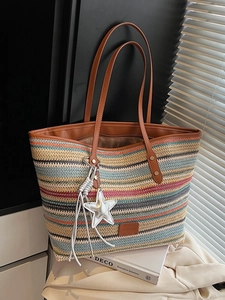 Rainbow woven straw tote bag with brown leather straps and colorful striped patterns