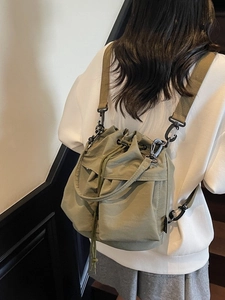 Multifunctional green canvas bucket bag for women with drawstring and metal hooks