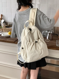 Chic beige drawstring backpack with adjustable buckles for commuting and casual wear