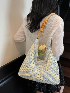 Blue and yellow woven crochet tote bag with wooden bead straps for summer beach vacations