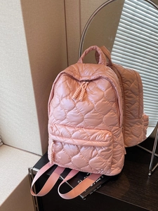 Pink heart quilted backpack with adjustable straps and front zipper pocket for women