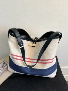 Large striped canvas tote bag with leather handles and toggles for summer leisure