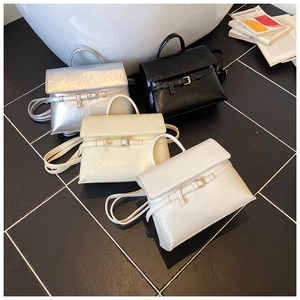 Top view of stylish flap handbags in silver, black, beige and white with strap details