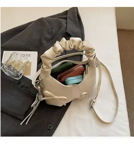 Internal view of cream bow shoulder bag showing spacious storage for daily essentials