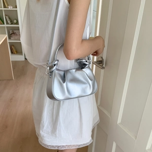 Close-up of the metallic silver pleated cloud bag featuring premium wrinkled texture