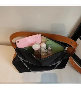 Macro view of spacious black canvas tote bag interior showing tablets and essentials