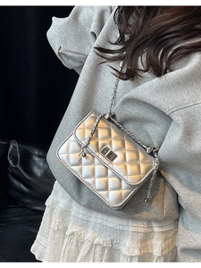 Silver quilted chain crossbody bag for women with metallic twist lock and elegant texture