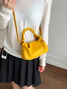 Chic ginger yellow ruched cloud bag in soft faux leather with elegant top handle strap