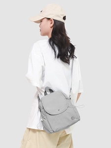 Sac à dos multifonction en nylon gris clair porté par un mannequin de profil