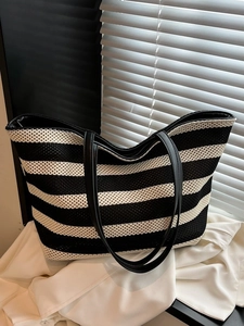 Minimalist black and white striped knit tote bag with long leather shoulder straps