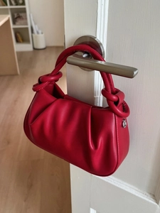 Fashionable red cloud crossbody bag with pleated design and unique knotted top handle