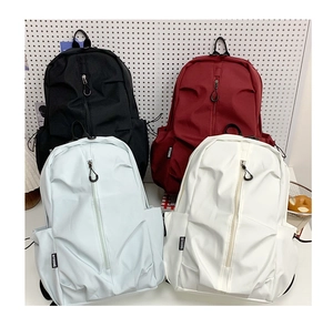 Multiple colors of water-resistant nylon backpacks in black, red, blue, and white