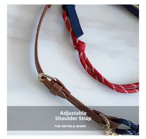 Detail view of adjustable leather shoulder strap and thick colorful braided ropes with gold buckles