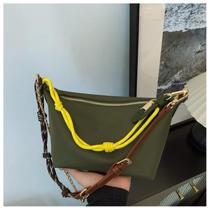 Detail of dark olive crossbody bag featuring multi-strap design and gold zipper