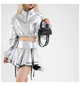 Close-up of black lychee grain leather handbag with silver metallic buckle detail