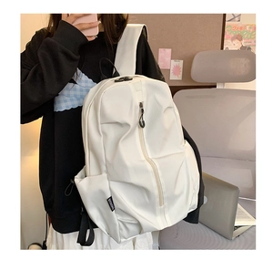 Detailed side view of white nylon backpack featuring dual zippers and woven brand label
