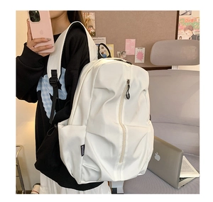 Side view of white water-resistant nylon backpack with BITXIONS label and zip pocket