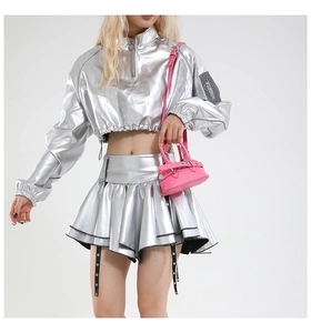 Detailed view of silver metallic pleated mini skirt with industrial buckled straps