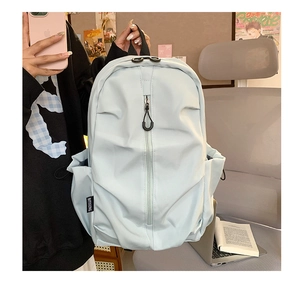 Detail of mint green waterproof nylon backpack showing side pocket and durable zipper