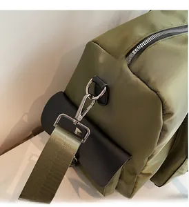 Detailed close-up of polished silver hardware and durable green nylon fabric