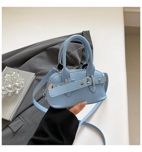 Close-up of mini light blue shell bag with litchi texture leather and silver buckle detail