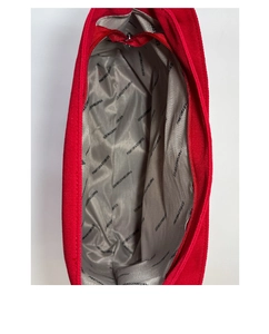 Detail view of red canvas tote showing printed inner lining and silver metal zipper closure
