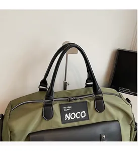 Detail of army green travel bag with durable black handles and NOCO logo branding